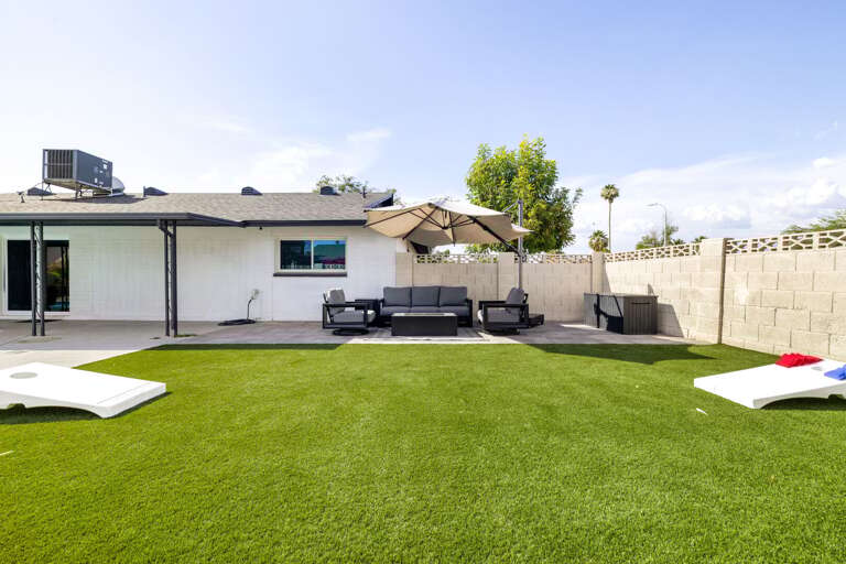 Spacious outdoor entertaining area featuring a large yard, patio seating, and plenty of room for games and gatherings.