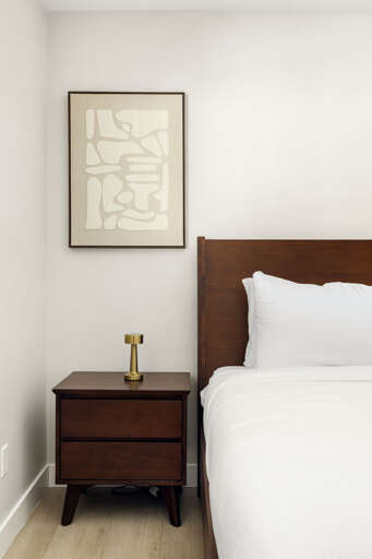 Stylish bedroom detail with warm wood accents and elegant modern touches.