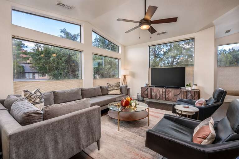 Gather, unwind, and soak in the views from this light-filled living space surrounded by nature.