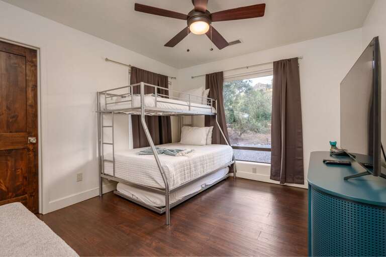 Perfect for families and groups, this cozy bunk room offers flexible sleeping arrangements and a TV for downtime after a day of adventure.