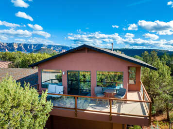 Welcome to Sanborn, where an expansive wraparound balcony showcases stunning red rock views and