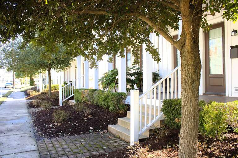 Row Of Residential Units With Front Porches And Landscaping Row Of Residential Units With Front Porches And Landscaping