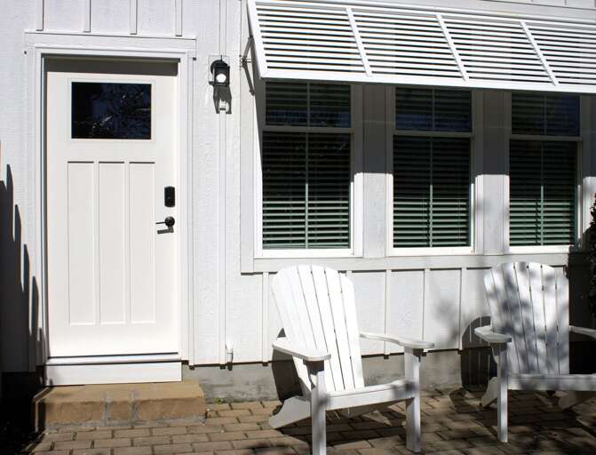 White Wooden Chair By Shuttered Windows And Door White Wooden Chair By Shuttered Windows And Door