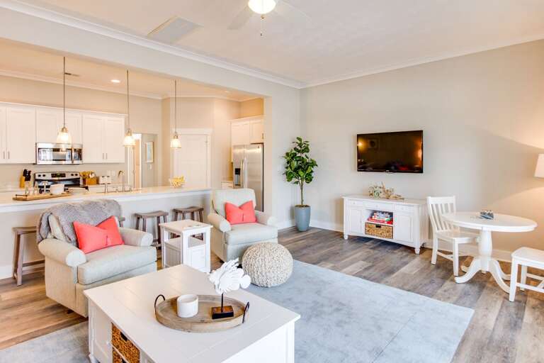 Living room with 50 inch flat screen TV, game table, games, sofa and two swivel chairs. Living room with 50 inch flat screen TV, game table, games, sofa and two swivel chairs.