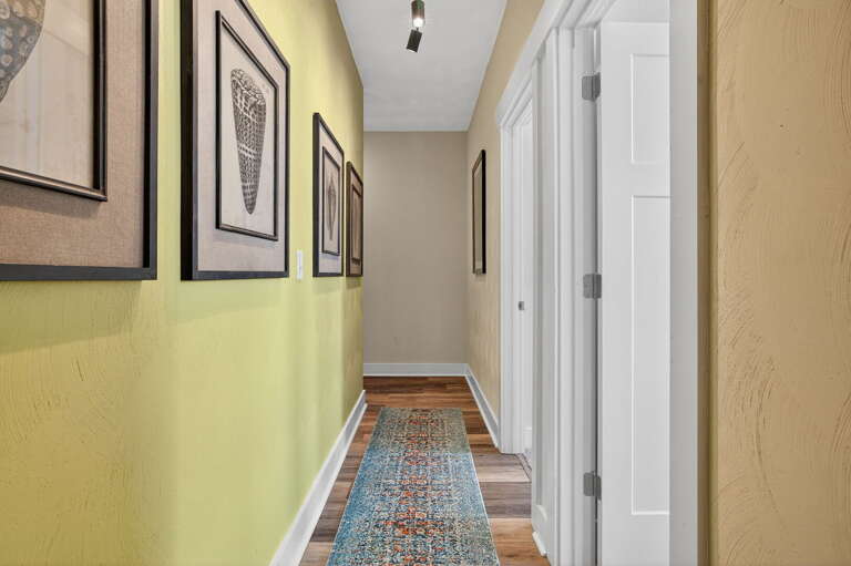 Second floor hallway. To the right, you will see the two queen bedrooms and at the end of the hallway, you will enter the bathroom to your left.
