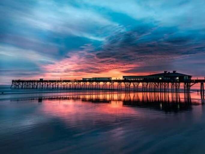 Sunglow Pier and Crabby Joe's Restaurant are a short walk away on the beach.