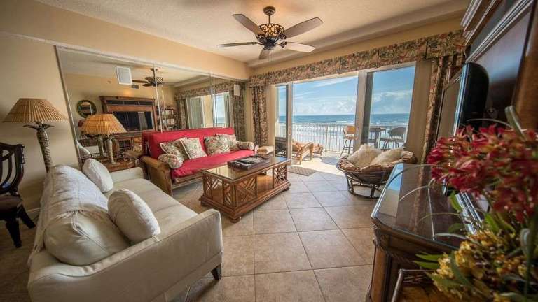 Living Room with large screen TV and balcony to oceanfront pool and beach Living Room with large screen TV and balcony to oceanfront pool and beach