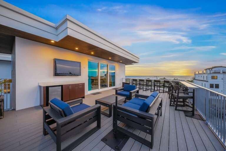 Vacation Rental Rooftop View At Sunset With Chairs And Outdoor TV