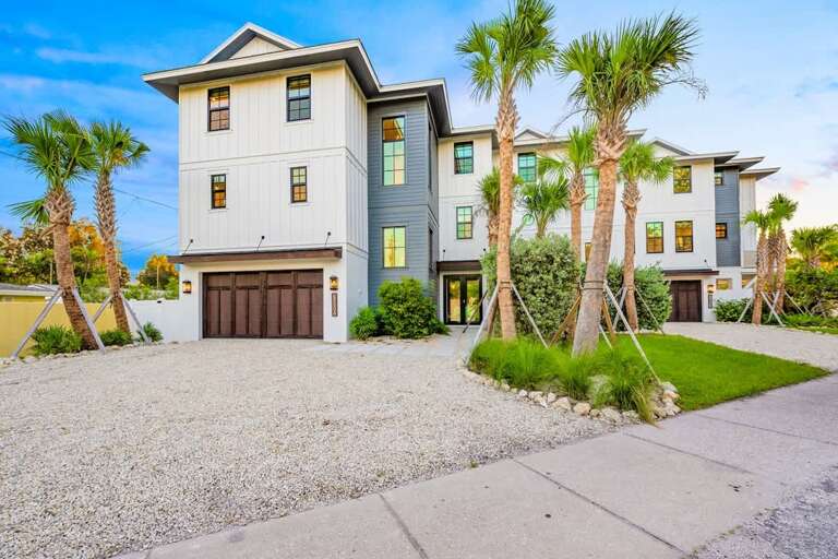 Three-story Building Surrounded By Palm Trees