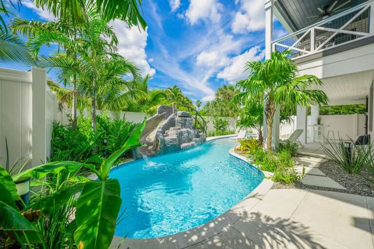 Tropical Palms Poolside, Blue Waters Winding Under Bright Sky