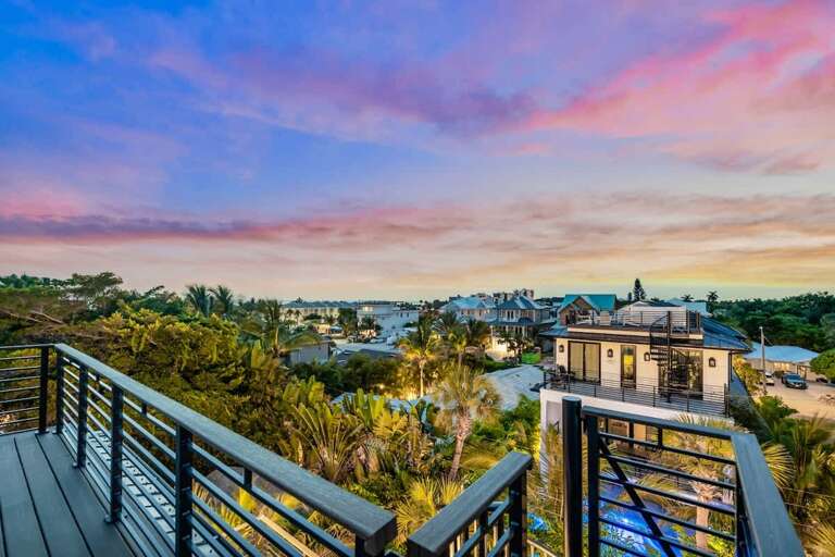 Sunset View From Vacation Rental Balcony Overlooking Lush Landscape