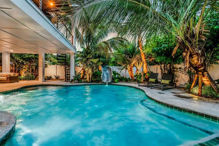 Tropical Poolside Paradise, Palms Partially Shading The Pristine Water