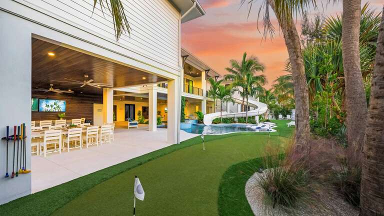 Poolside Paradise With Plush Palms Under A Pastel Sunset