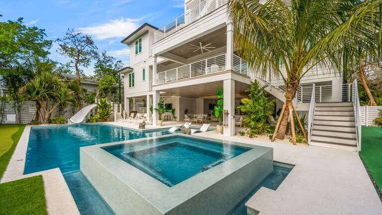 Daytime - Rear Elevation - Private Pool/Spa/Slide - Mini Golf - Multi-Sport Court