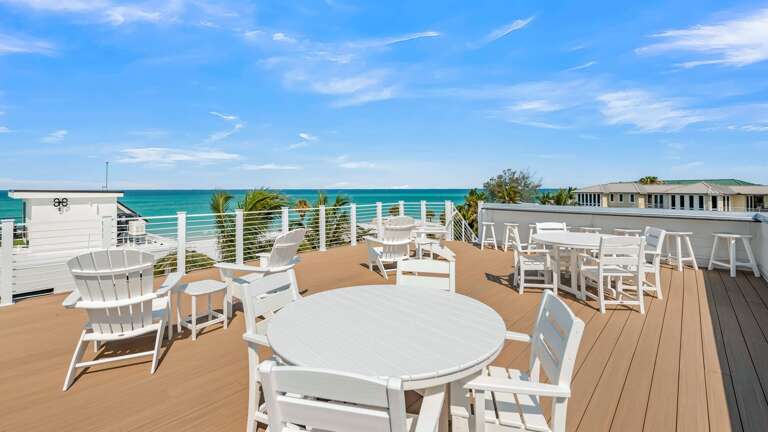 Daytime - Aerial Drone - Rooftop Deck - Gulf Views - Dining - Lounge - Bar Seating Daytime - Aerial Drone - Rooftop Deck - Gulf Views - Dining - Lounge - Bar Seating