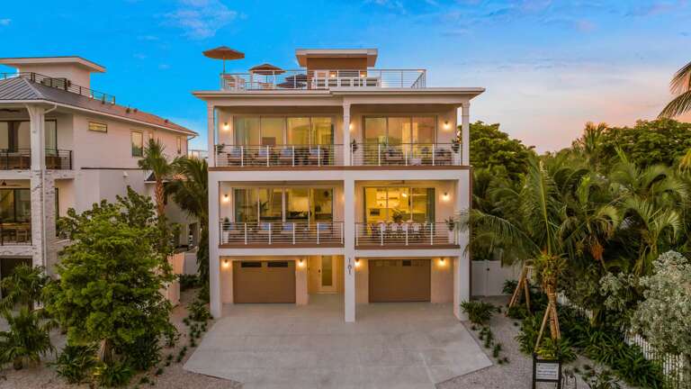 Three-story Structure With Spacious Balconies, Surrounded By Lush Greenery