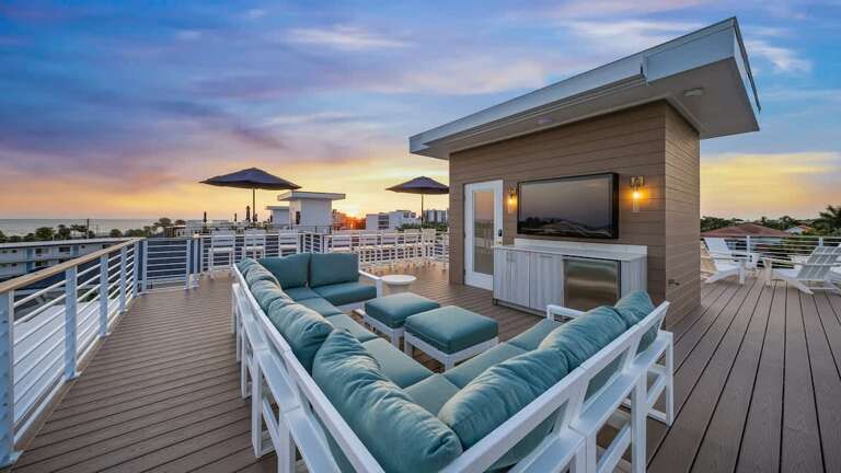 Rooftop Retreat With Plush Seating Under Sunset Skies
