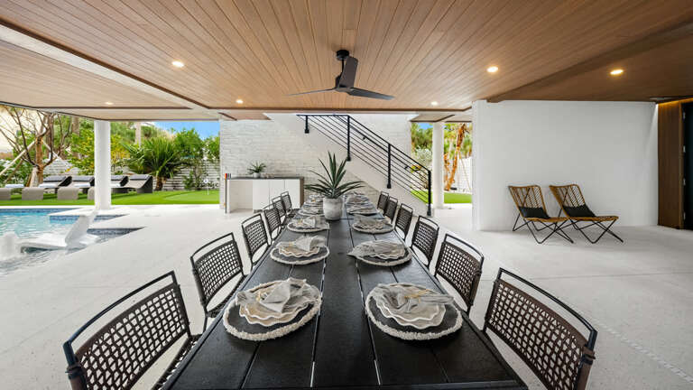 Spacious Outdoor Dining Area With Poolside View And Staircase