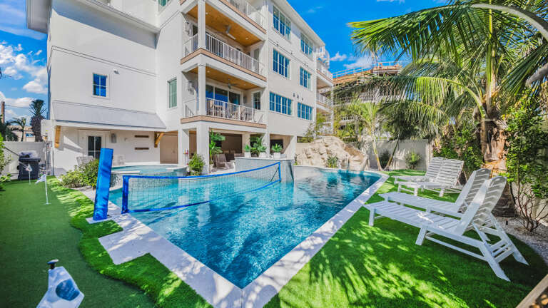 Pristine Poolside, Lush Lawn, And Palm Panorama