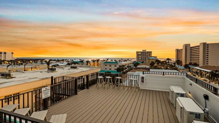 Sunset View From Spacious Rooftop Deck Overlooking Urban Skyline
