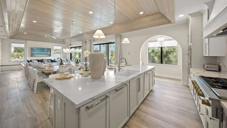 Spacious Kitchen And Dining Area In Vacation Rental With Large Windows