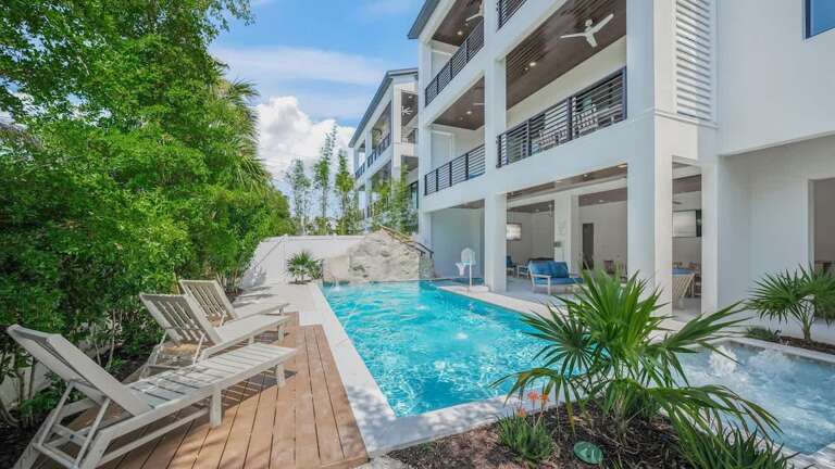 Poolside Paradise, Palm-fringed With Placid Blue Waters By Pristine White Building