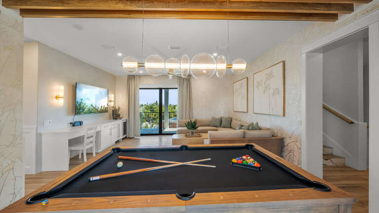 Living Space With Billiards Table, Beige Tones, And Balcony View