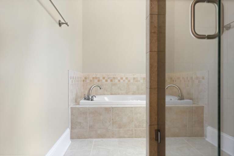 Beige Bathroom With Built-in Bathtub And Shower In Vacation Rental