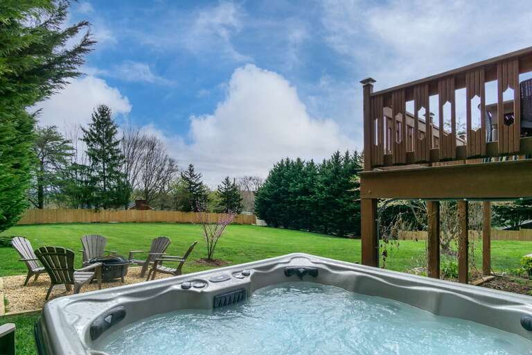 Unwind in the Private Hot Tub with Scenic Backyard Views.