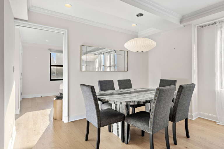 Minimalist Dining Space With Sleek Seats And Shiny Surfaces Minimalist Dining Space With Sleek Seats And Shiny Surfaces
