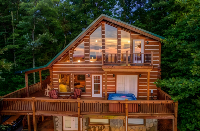Nestled among lush trees in a quiet area in Sevierville, TN, this 3-story log cabin features an upstairs balcony and deck overlooking the Smoky Mountains.