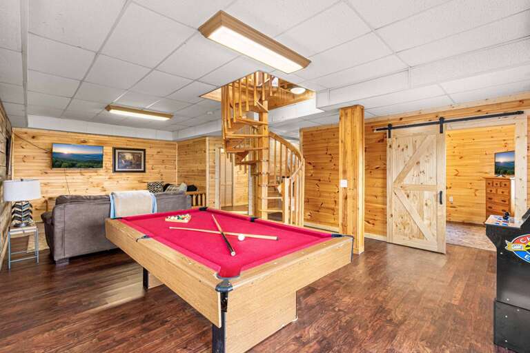 Rustic Room With Red Pool Table And Spiral Staircase