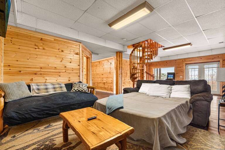 Wood-paneled Room, Spiral Staircase, Sofas, Small Table