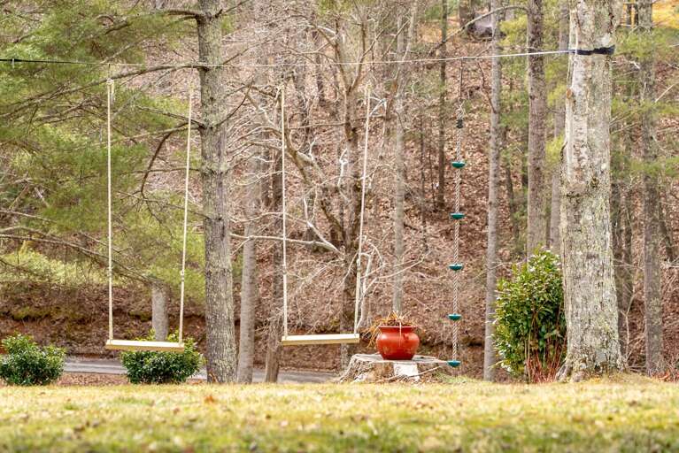 Children and adults alike will relish in the carefree feeling of swinging on these wooden swings, suspended between the trees.