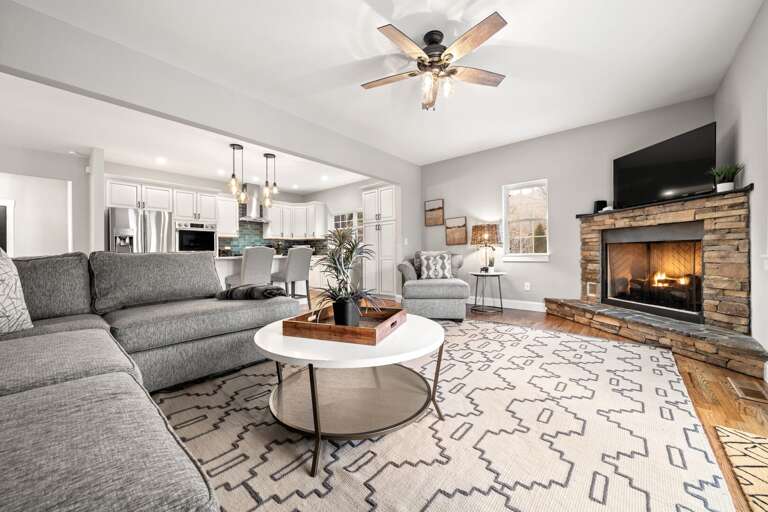 The gas fireplace and its beautiful stonework sets the mood for a cozy night in. Log in to your favorite streaming apps on a 65” Roku HDTV.