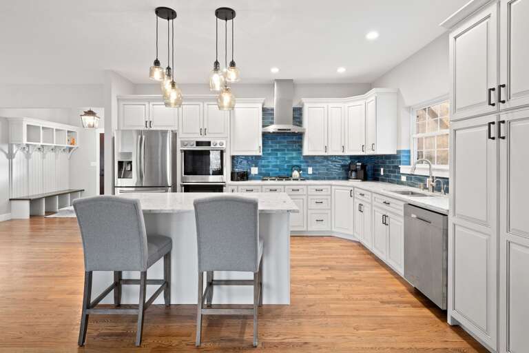 Indulge in the luxury of high-end Samsung appliances, white quartz countertops and island seating.