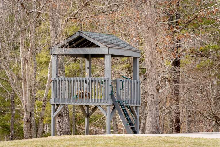 To young children, this wooden playhouse offers the wonder of a treehouse, but at a safer height.