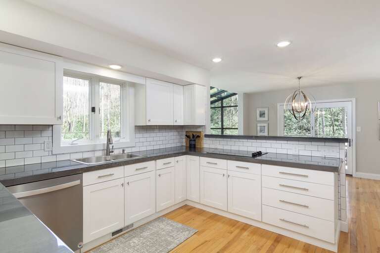 Enjoy luxe countertops and high-end stainless steel appliances in this brand-new modern kitchen.