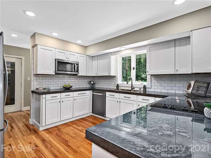 Enjoy luxe countertops and high-end stainless steel appliances in this brand new modern kitchen.