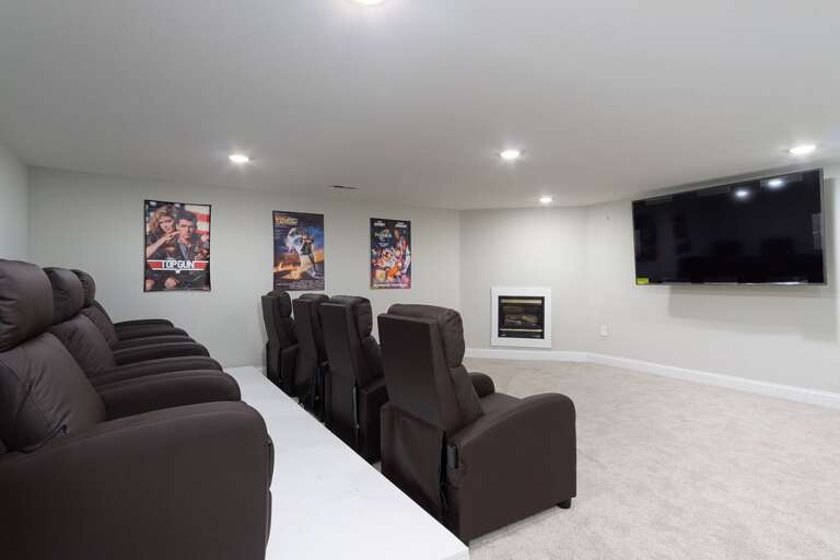 Indulge in the 8-seat movie room with massaging recliners! Make popcorn and kick back in front of a 70” Roku HDTV and gas fireplace.