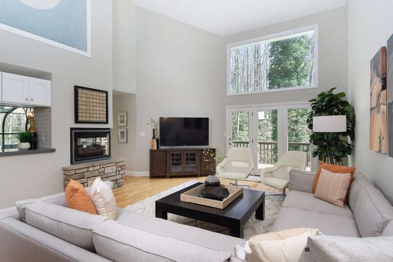 The living room's high ceiling helps the space feel more airy and spacious for everyone to gather.