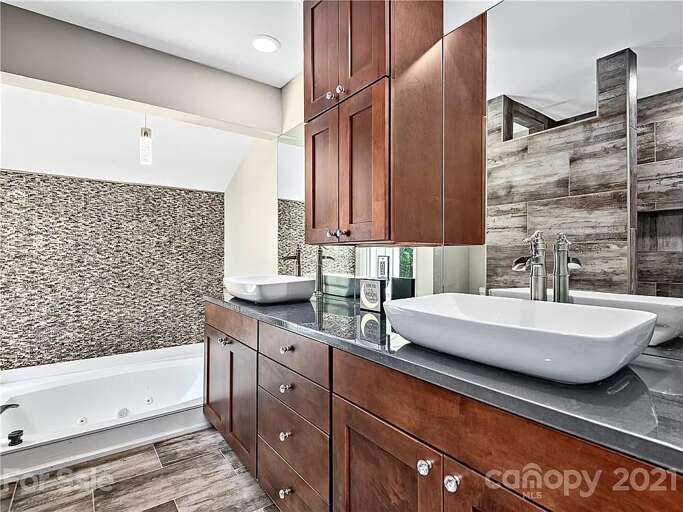 The primary bedroom's ensuite bathroom offers a unique and luxurious experience.