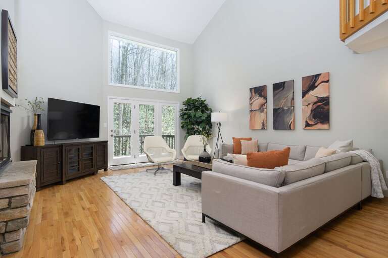 Stream your family's favorite shows on a 65” Roku HDTV, or open up the French doors to access the deck.