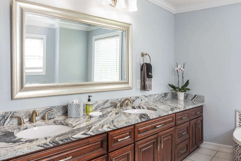 Enjoy ample space for your toiletries with this double vanity in the primary bedroom's ensuite bathroom. Enjoy ample space for your toiletries with this double vanity in the primary bedroom's ensuite bathroom.