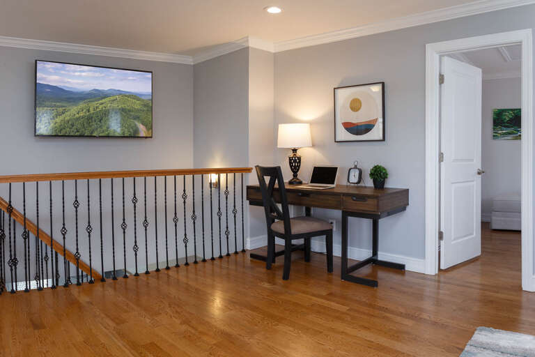 The workspace includes a desk and comfortable chair, ideal for checking emails in between your Blue Ridge adventures!
