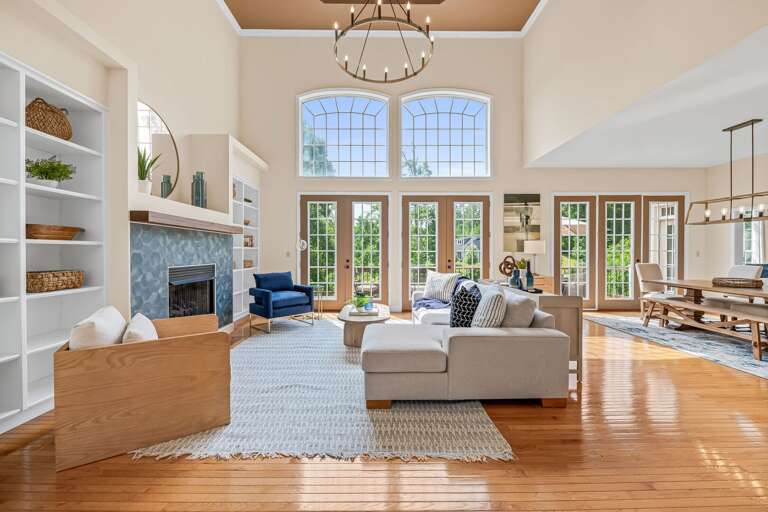 Spacious Living Room With Fireplace And Tall Windows