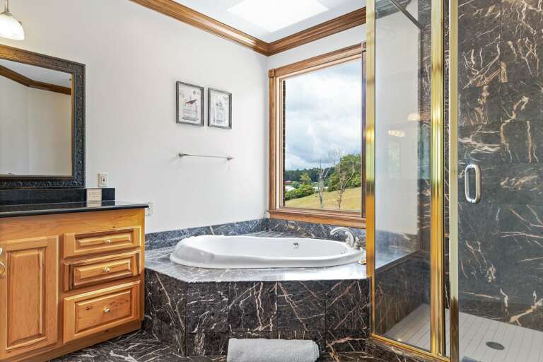 You'll love the luxurious marble, double vanity and jet tub in the primary bedroom's ensuite bathroom.
