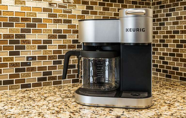 Coffee Maker On Granite Counter With Mosaic Tiles
