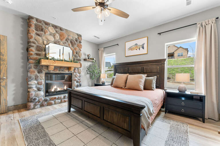 Interior View Of A Bedroom With A Fireplace And Stone Wall