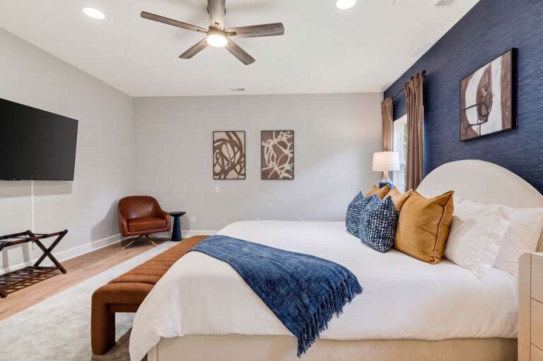 [Bedroom 1] Enjoy a comfortable and spacious primary room equipped with a private luxury ensuite bath.